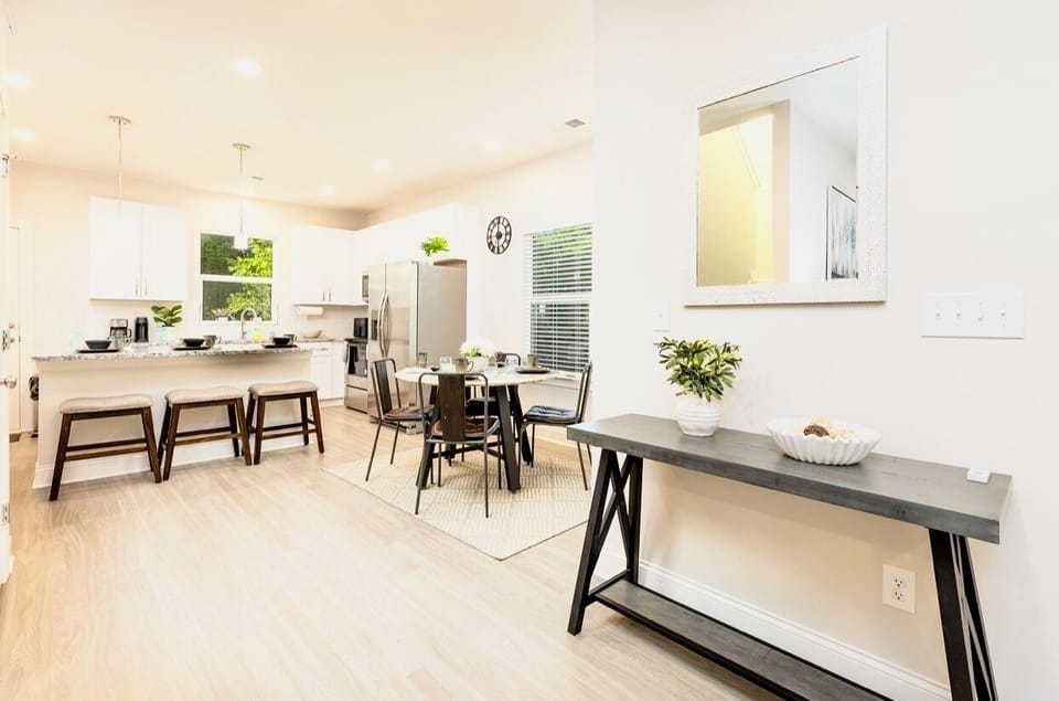 Open concept living room is connected to dining area and kitchen 