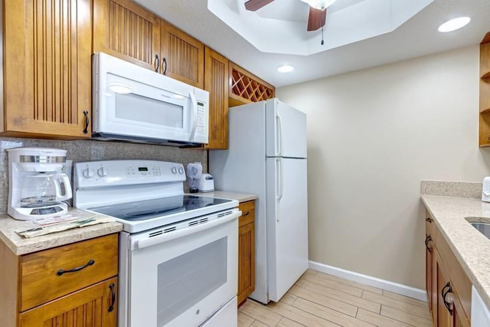 This fully equipped kitchen boasts modern appliances and ample counter space, making family meal preparations both convenient and enjoyable.