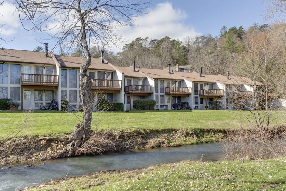 The charming exterior of cottages at Bryce Resort showcases private balconies and lush greenery, promising a tranquil mountain getaway.