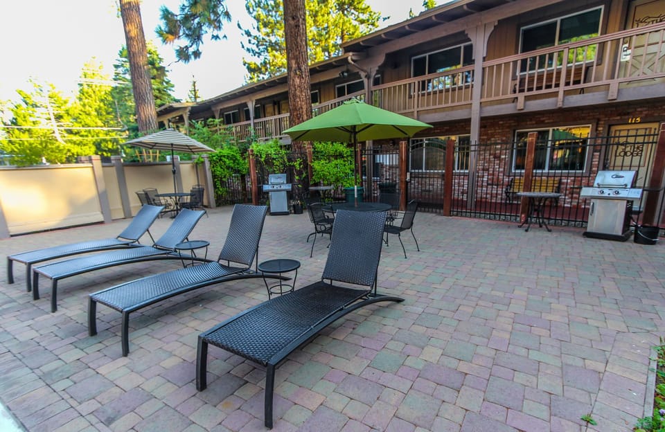 Outdoor lounge area with sun loungers and grill