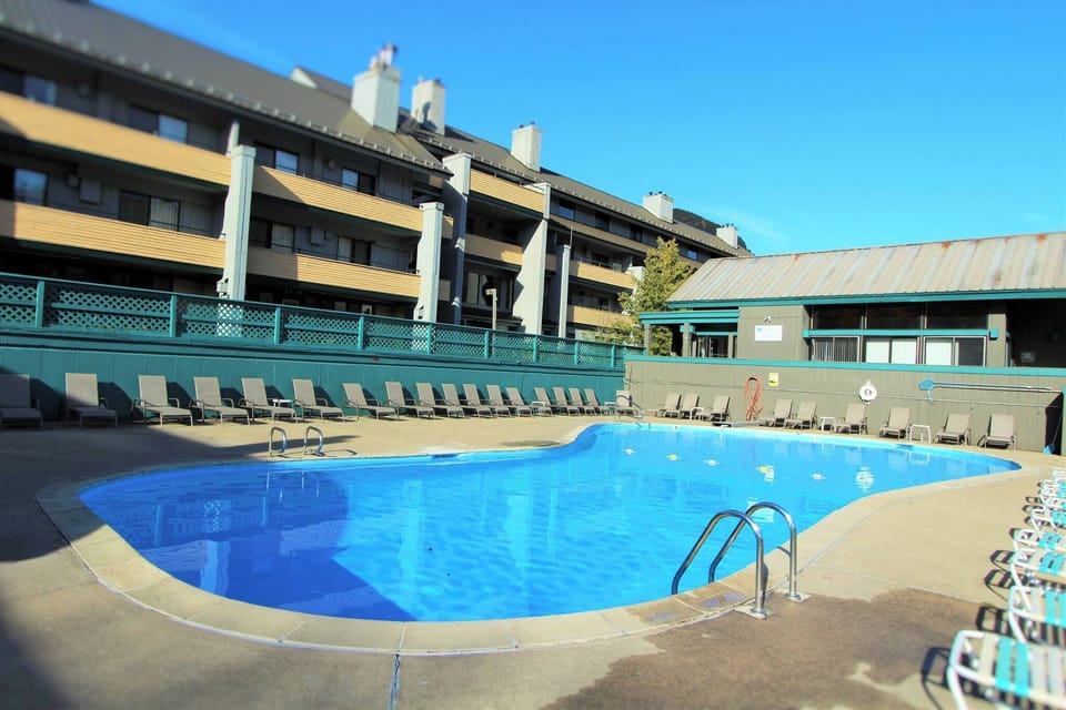 Dive into the relaxing outdoor pool, surrounded by sun loungers, providing the perfect spot to unwind after a day of adventure.