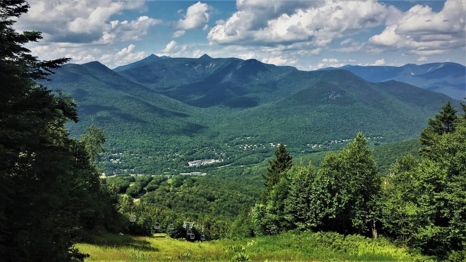 Marvel at expansive panoramic views of the surrounding mountains and valleys, highlighting the natural beauty and adventure opportunities that await nearby.