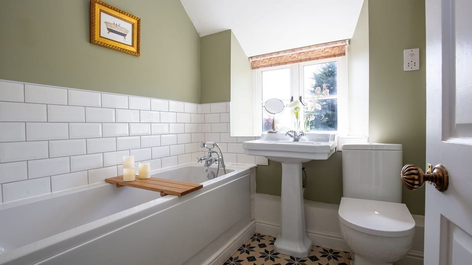 The bathroom sits between the two bedrooms