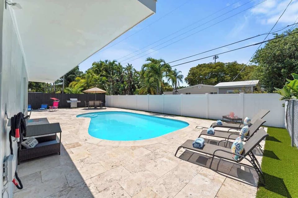 Relax and unwind in this private tropical oasis. Featuring a sparkling pool, sun loungers, and fun floaties, perfect for your next getaway!