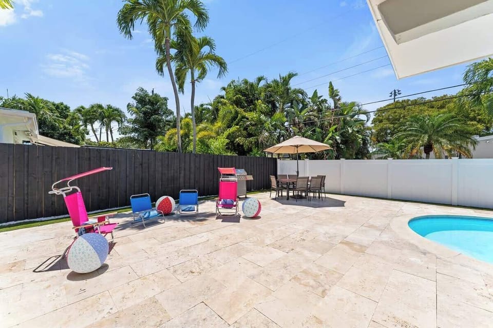 Relax and unwind in this private tropical oasis. Featuring a sparkling pool, sun loungers, and fun floaties, perfect for your next getaway!