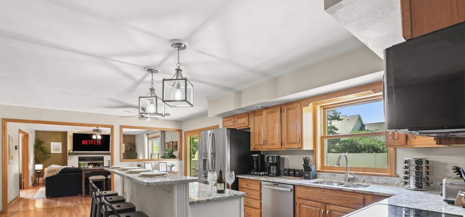 Fully stocked kitchen with 4 barstools at the breakfast bar, complimentary coffee and tea station, and visibility to the living room and back yard.