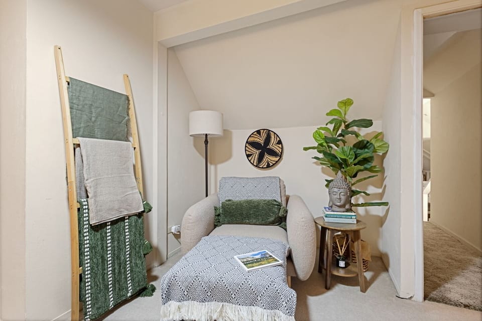 Bedroom 3. Quiet Retreat | A cozy spot to read, journal, meditate, enjoy your morning coffee with a view of the trees, or simply take a peaceful moment to yourself. Leads to bedroom 4. 