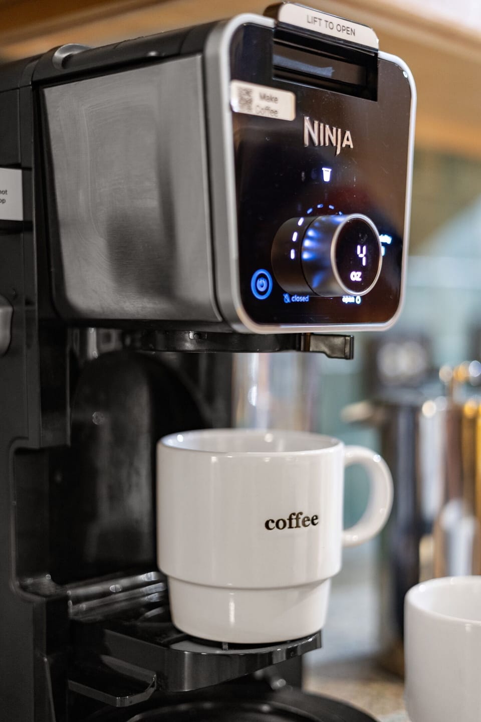 Thoughtfully stocked coffee and tea bar with drip coffee, Italian espresso maker, French press, drip and pod coffee, a coffee grinder and hot water kettle and tea pot for tea lovers. 