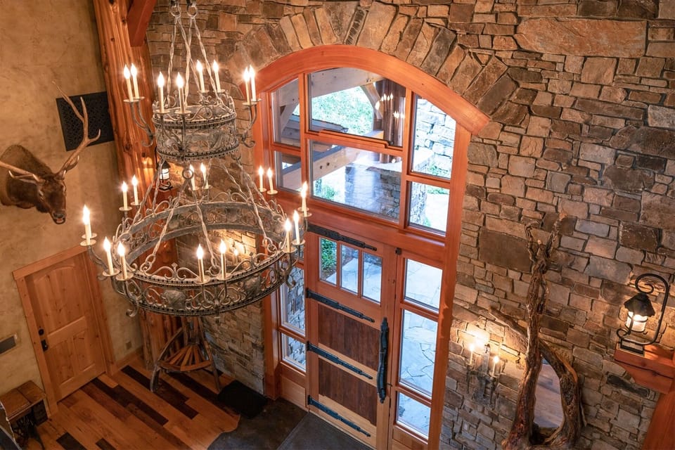 Elegant meets rustic in this beautiful entryway, complete with custom chandelier | Main Level