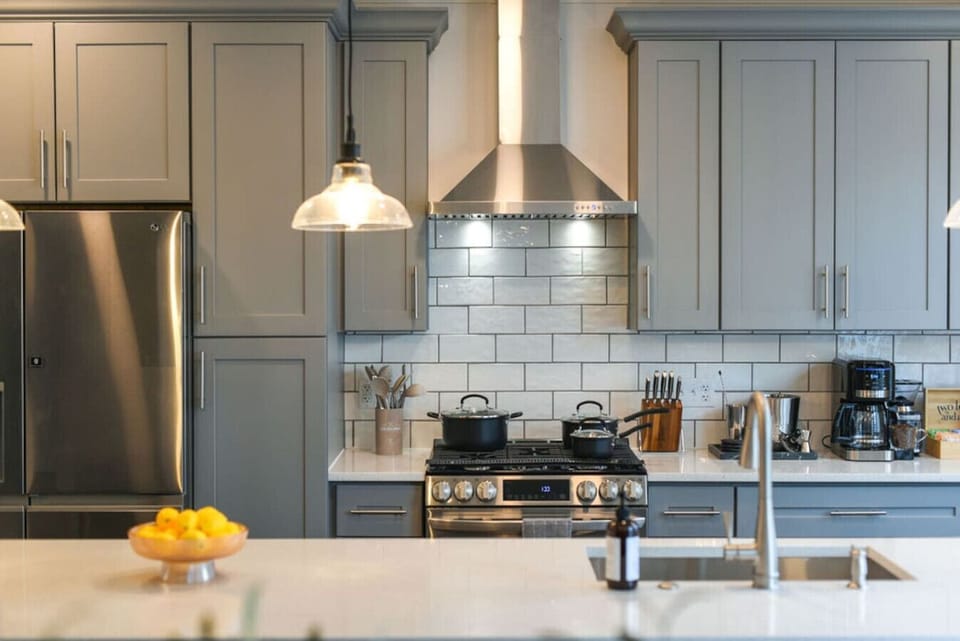 A sleek, fully equipped kitchen featuring stainless steel appliances, a gas stove, and plenty of space for cooking.