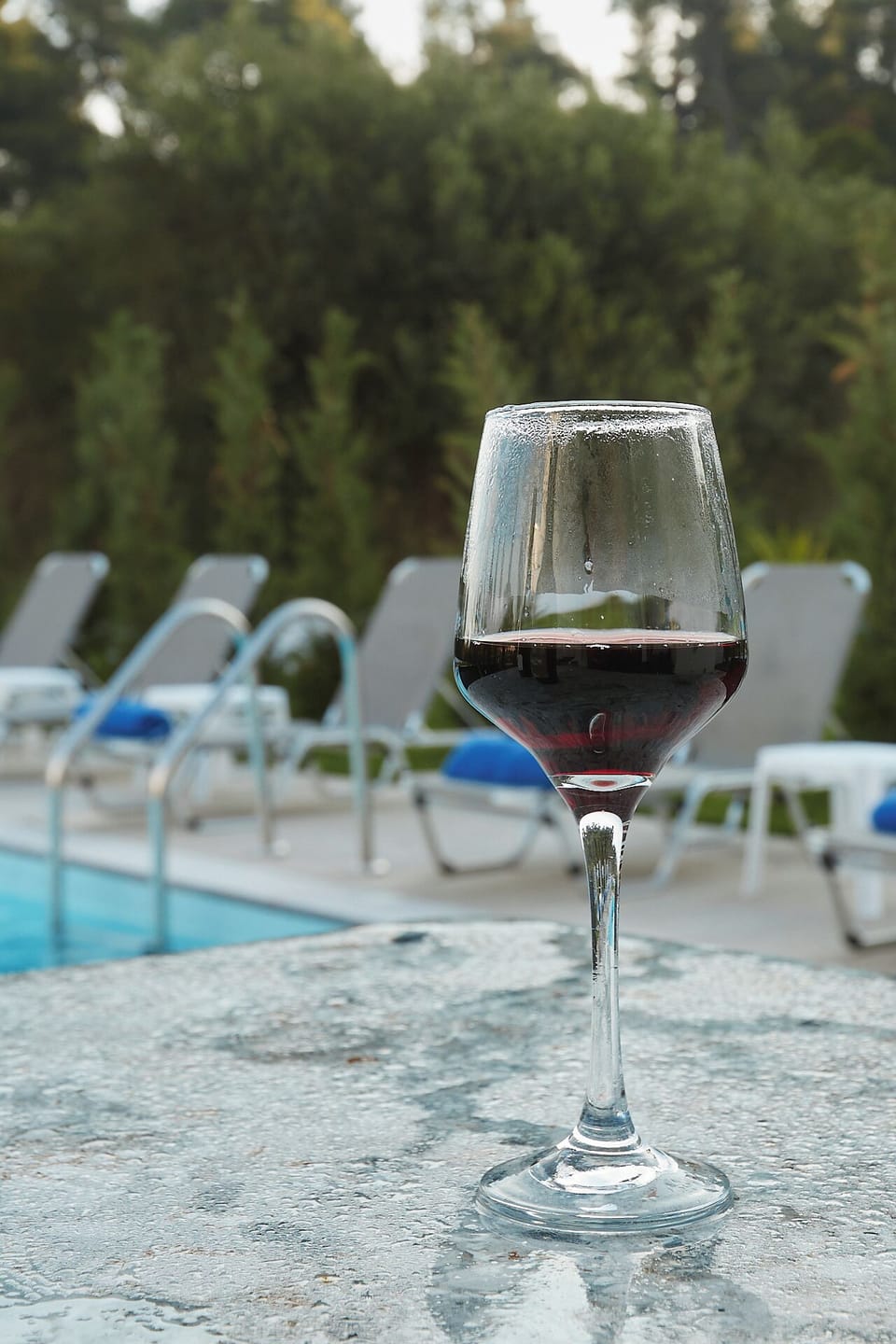 Glass of wine by the private pool – relaxing luxury villa experience in Halkidik