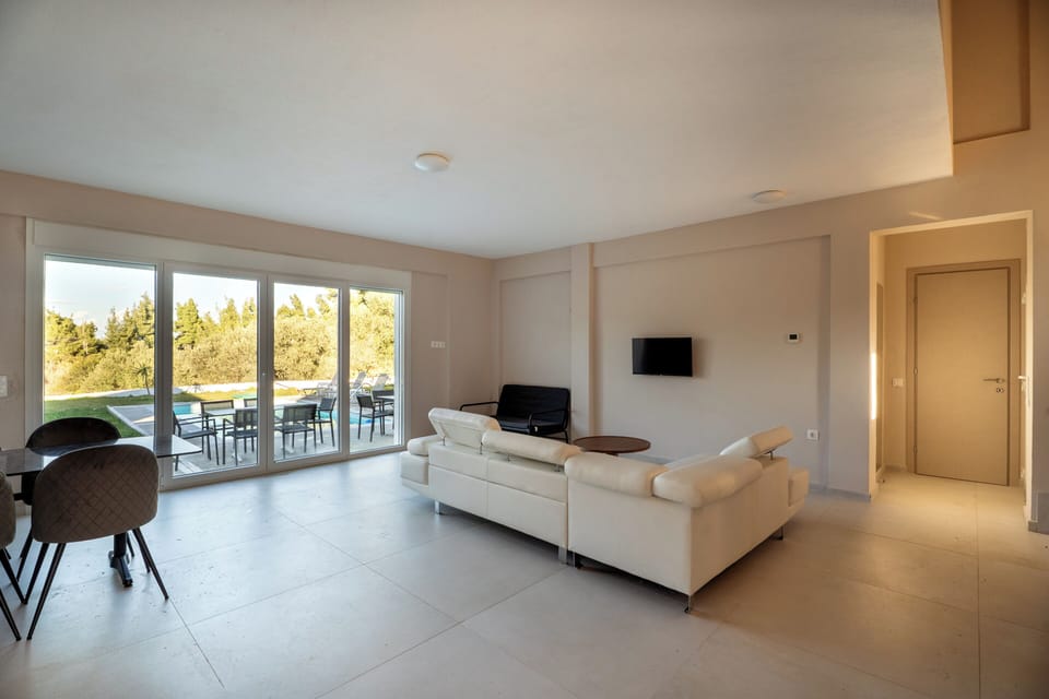 Bright living room with pool view & garden access-modern luxury villa-Halkidiki