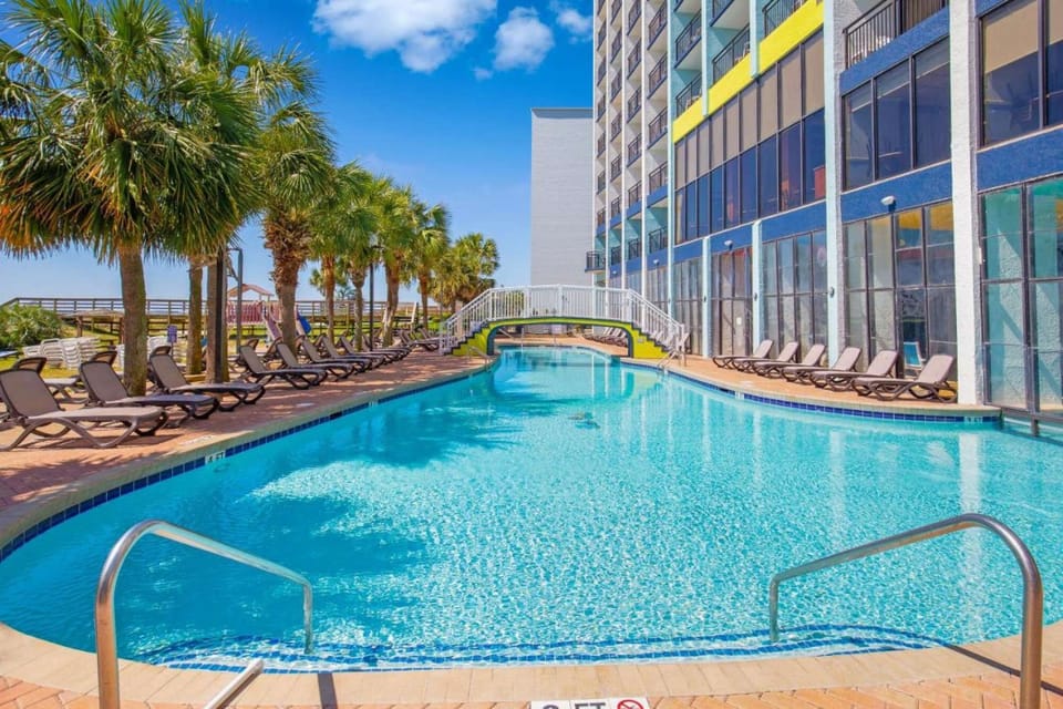 -Sunny poolside with palm trees