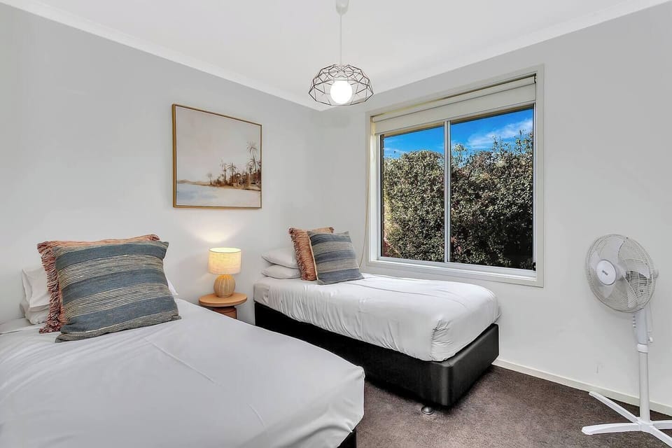Great for kids or friends, the third bedroom offers two single beds and window blinds.