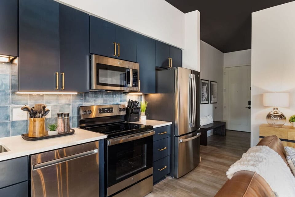 Fully equipped kitchen flows seamlessly into the sophisticated living space.