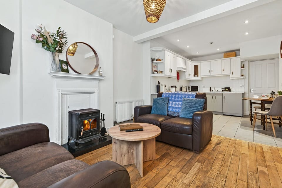Living room with wood burning stove and open plan kitchen