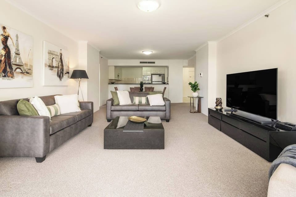 Gather in the living area where two comfy sofas and a smart TV set the scene for movie nights—whether it's a Netflix binge or Disney+ fun for the kids.