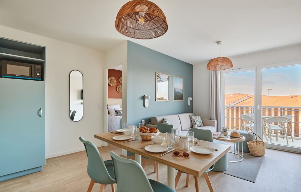 The tranquil bedroom showcases stylish decor with warm tones and plush bedding, creating a restful retreat just minutes from the beach.