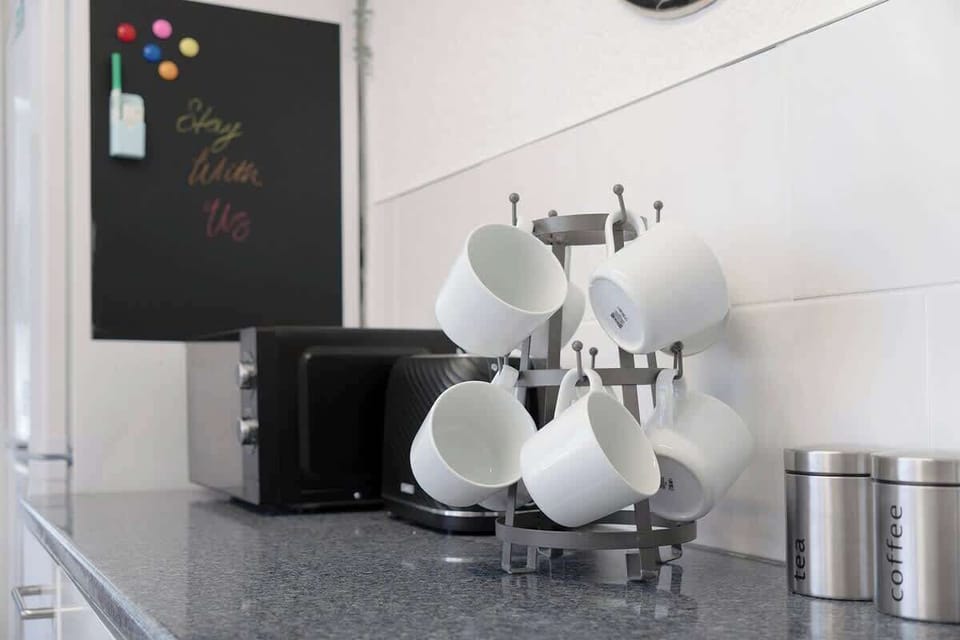 Kitchen equipped with all essentials, including an oven, fridge, and full cookware set.