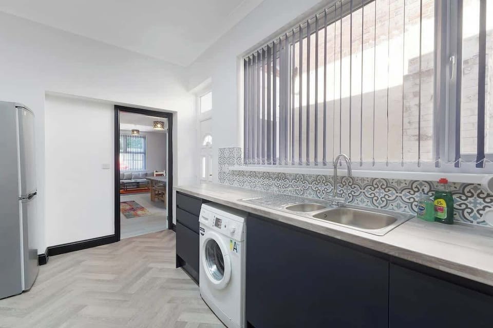 Kitchen equipped with all essentials, including a washer & dryer, oven, fridge and full cookware set.