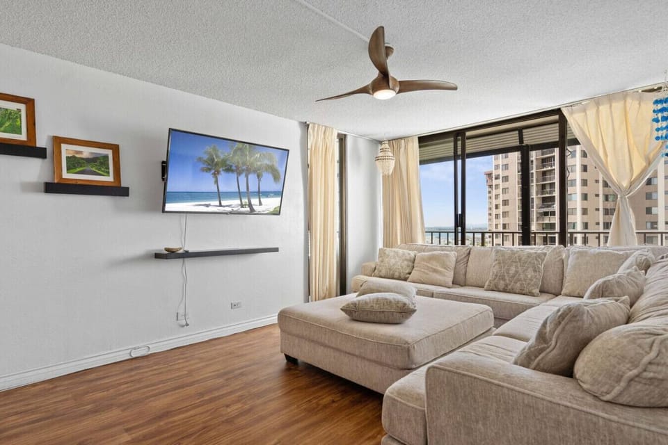 Kick back and relax in the sunlit living room, equipped with remote controlled shades for the lanai.