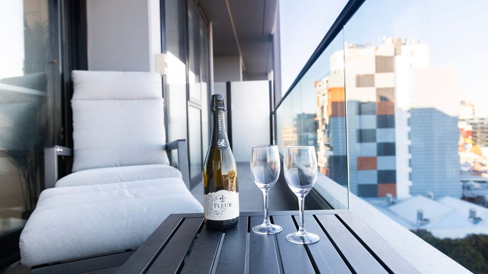 Pour a glass of wine and unwind on this private balcony overlooking vibrant urban vistas.