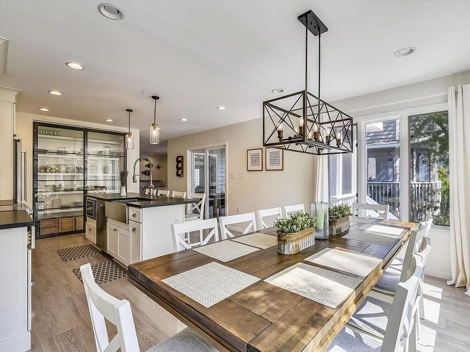 The open-plan kitchen and dining area showcases elegant furnishings, a large dining table, and a modern culinary space equipped with a stylish island and smart appliances for entertaining.