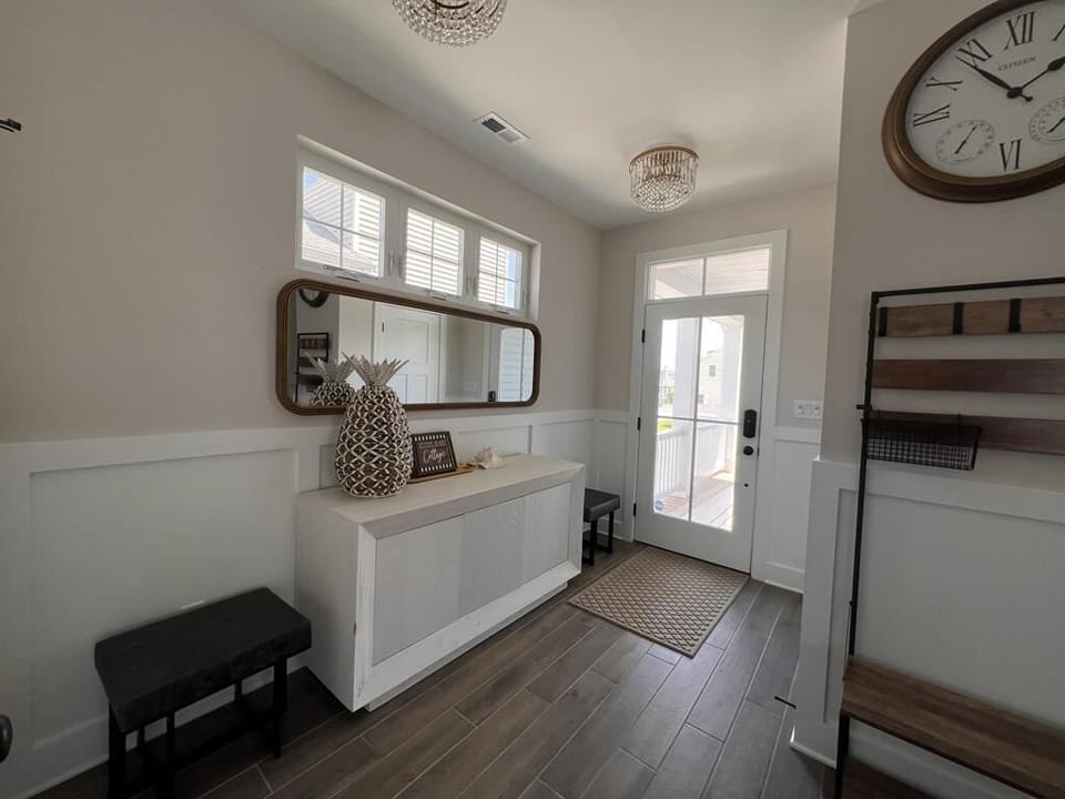 Bright and airy hallway leading to the heart of the home, featuring elegant finishes and a cozy ambiance.