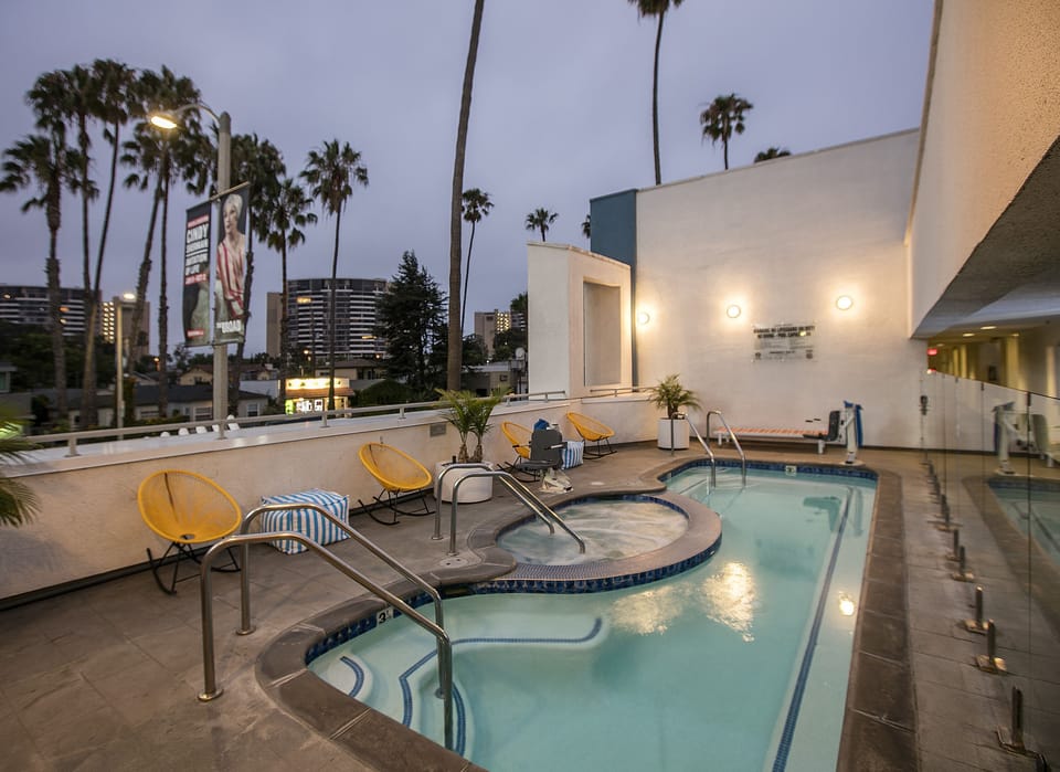 Dive into a serene pool deck framed by palm views.