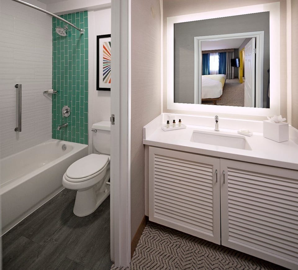 Start the day at a sleek vanity with glowing mirror light.