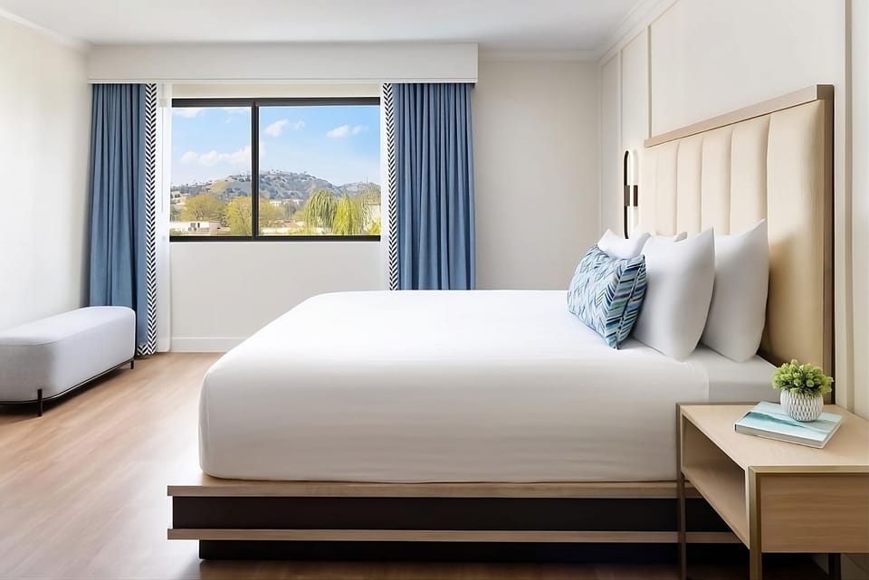 Wake up refreshed beside sunny windows and crisp linens.