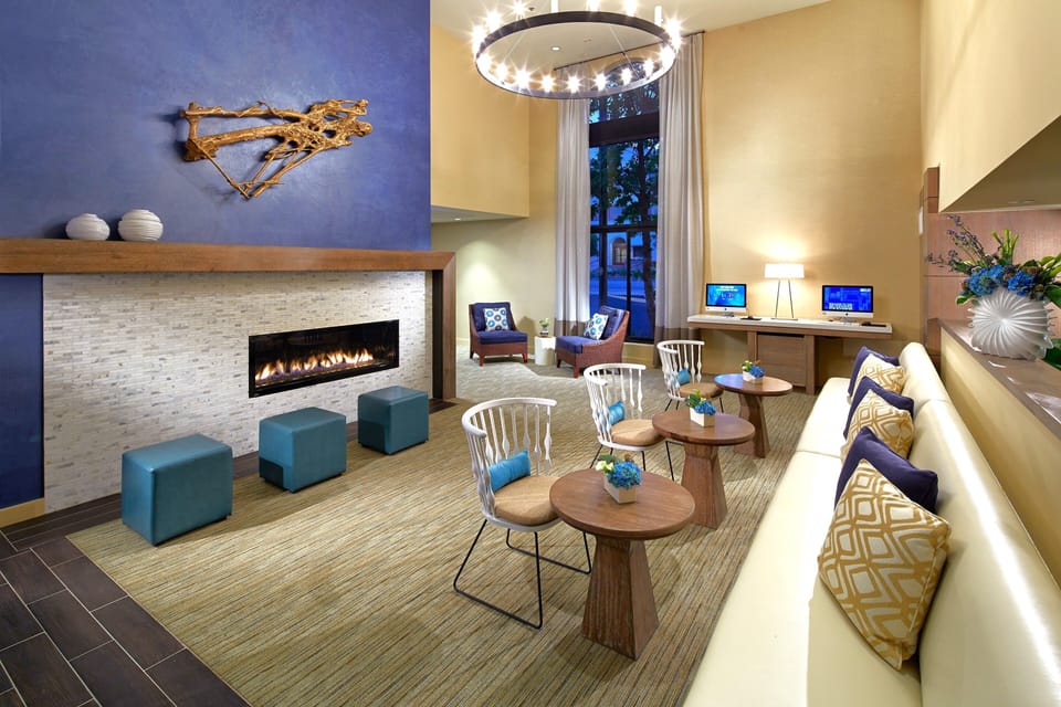 Settle in by the glowing fireplace under a dramatic chandelier.