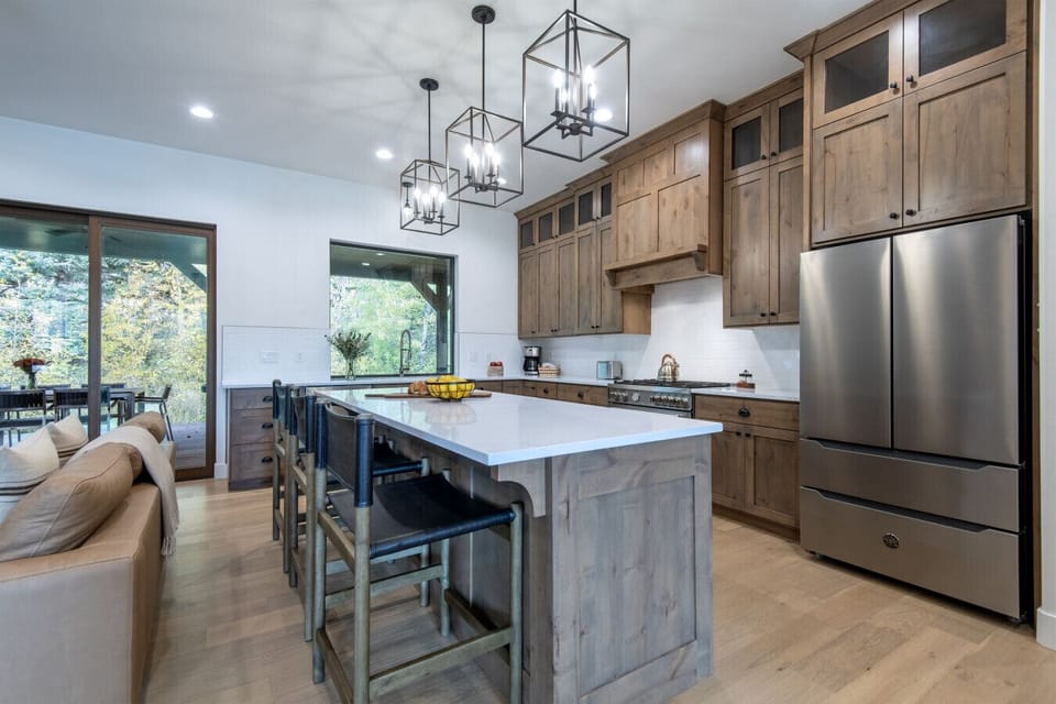 Open concept kitchen with stainless steel appliances and granite countertops