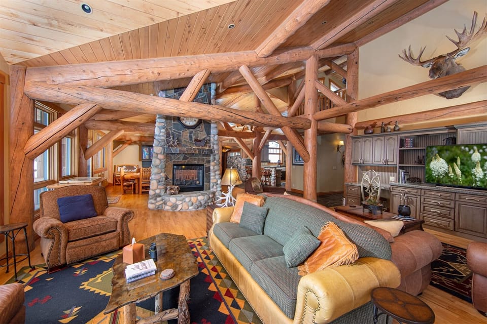 The pass-through fireplace connects the living room, dining room & kitchen | Main Level