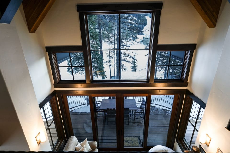 The cathedral ceiling and expansive windows enhance the beauty of the living space | Upper Level