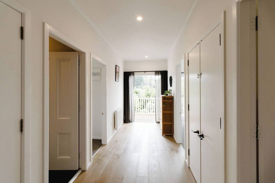 Downstairs hallway with access to three bedrooms, bathroom, laundry and second balcony.