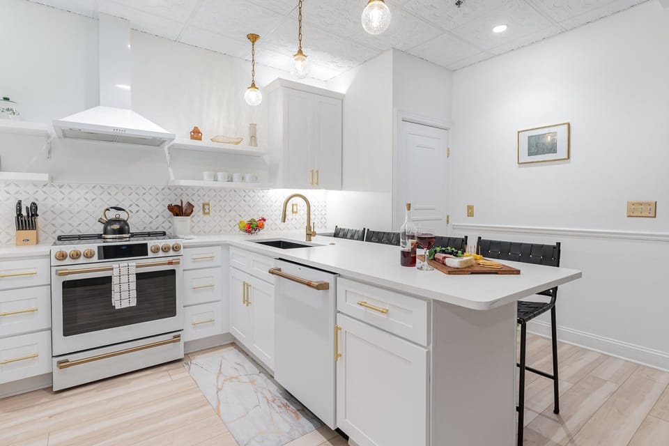 Fully Equipped Kitchen featuring stainless steel appliances, open counter space, and bar seating for 4 guests.