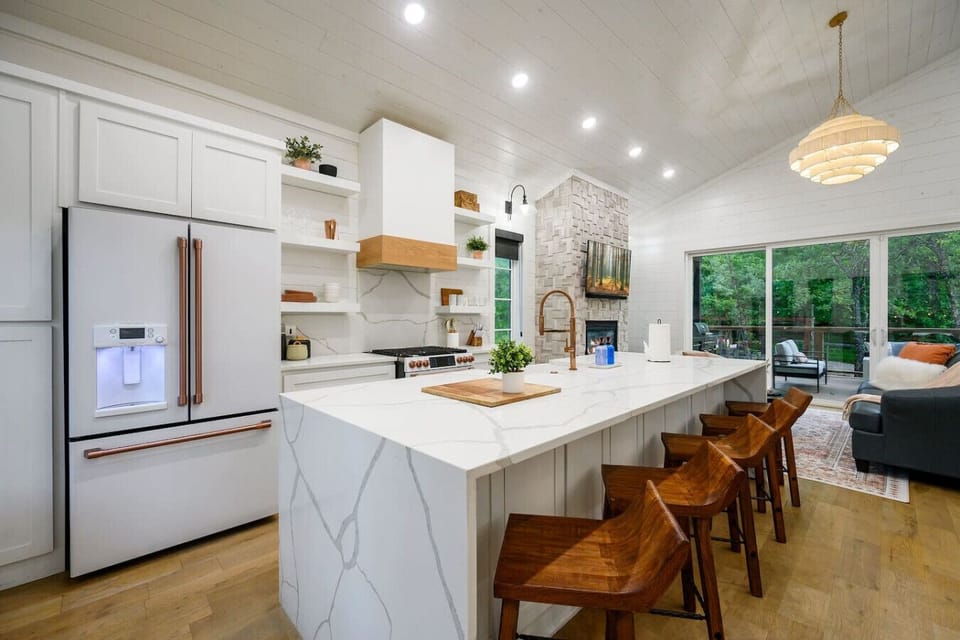 Wood accents, marble touches, and a glow from the fireplace—this is cabin luxury reimagined.