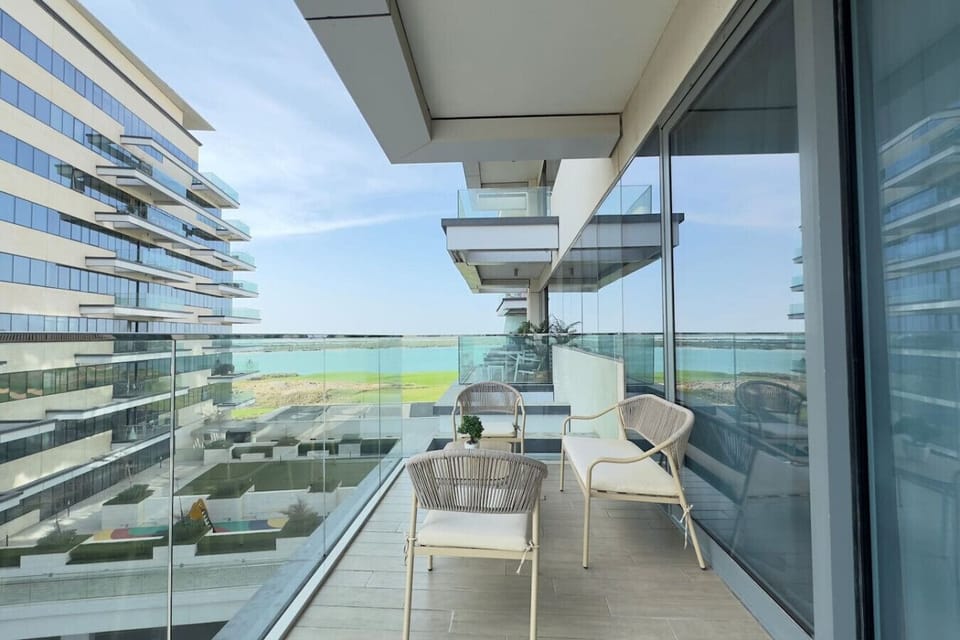 Unwind on the balcony with breathtaking views and a cozy seating area, perfect for relaxation.