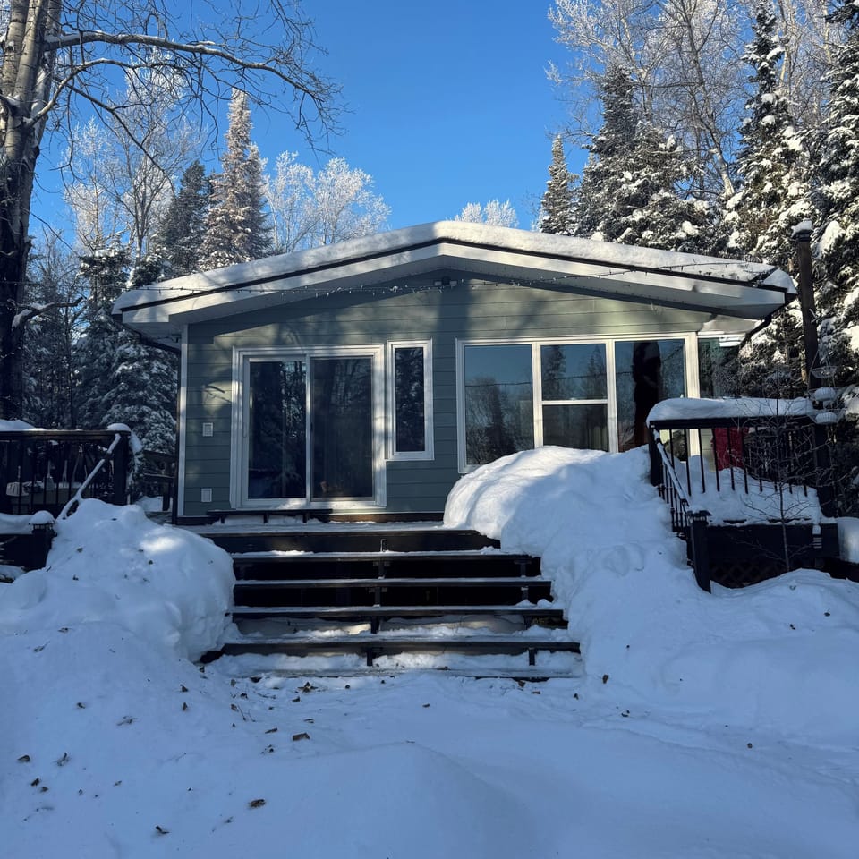 Winter cabin retreat in Manitoba forest getaway.