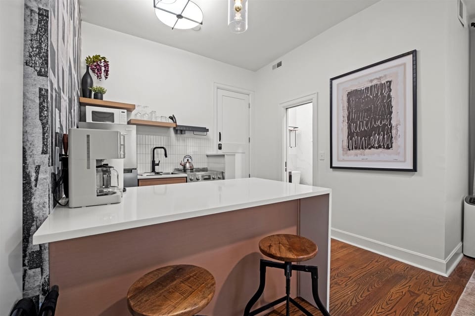 Another view of the kitchen island highlighting clean lines, ample prep space, and thoughtful design in this first-floor studio.