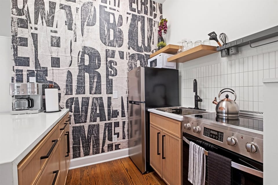 Dedicated coffee station with countertop appliances, plus a full-size refrigerator and stove—ideal for both short and extended stays.