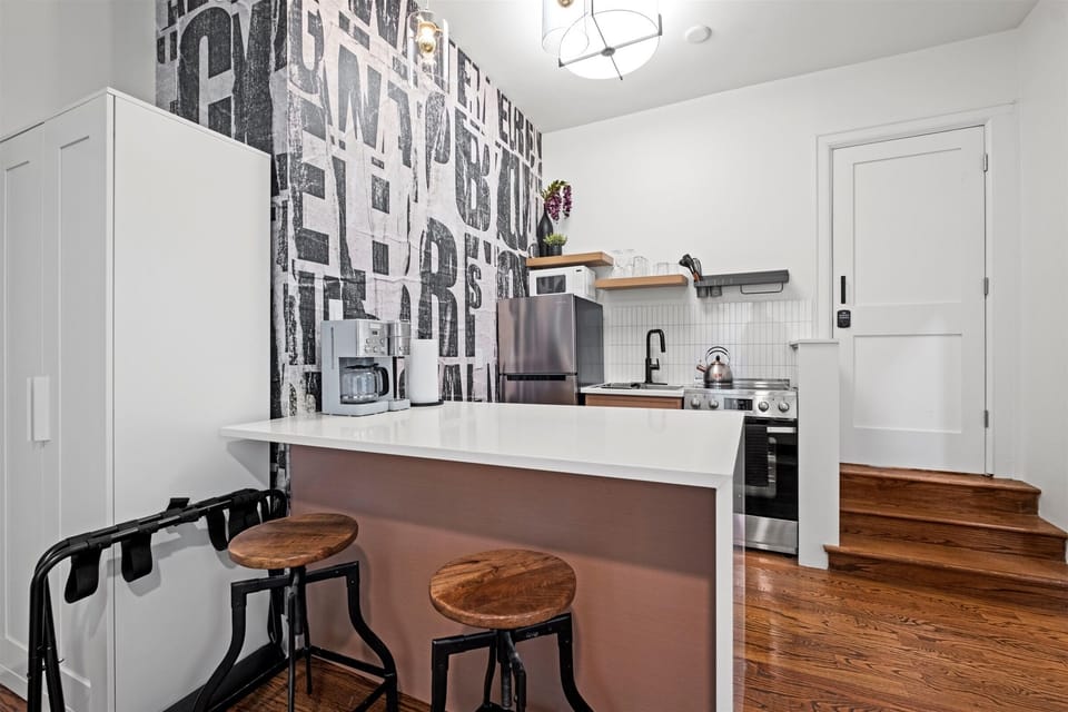 Stylish full kitchen with a spacious island and bar seating—perfect for casual meals, morning coffee, or planning your day in Kansas City.