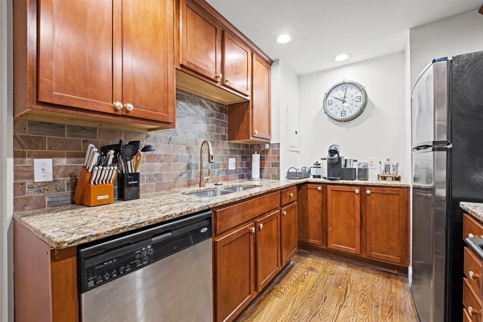 Well-stocked prep space with cookware, knife set, dishwasher, and coffee essentials—everything you need to feel at home.