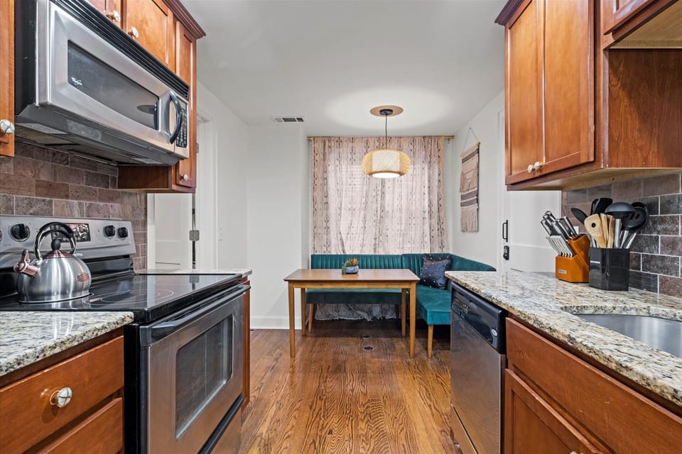 Efficient galley-style kitchen layout with easy flow into the dining and sleeping area of this thoughtfully designed studio.