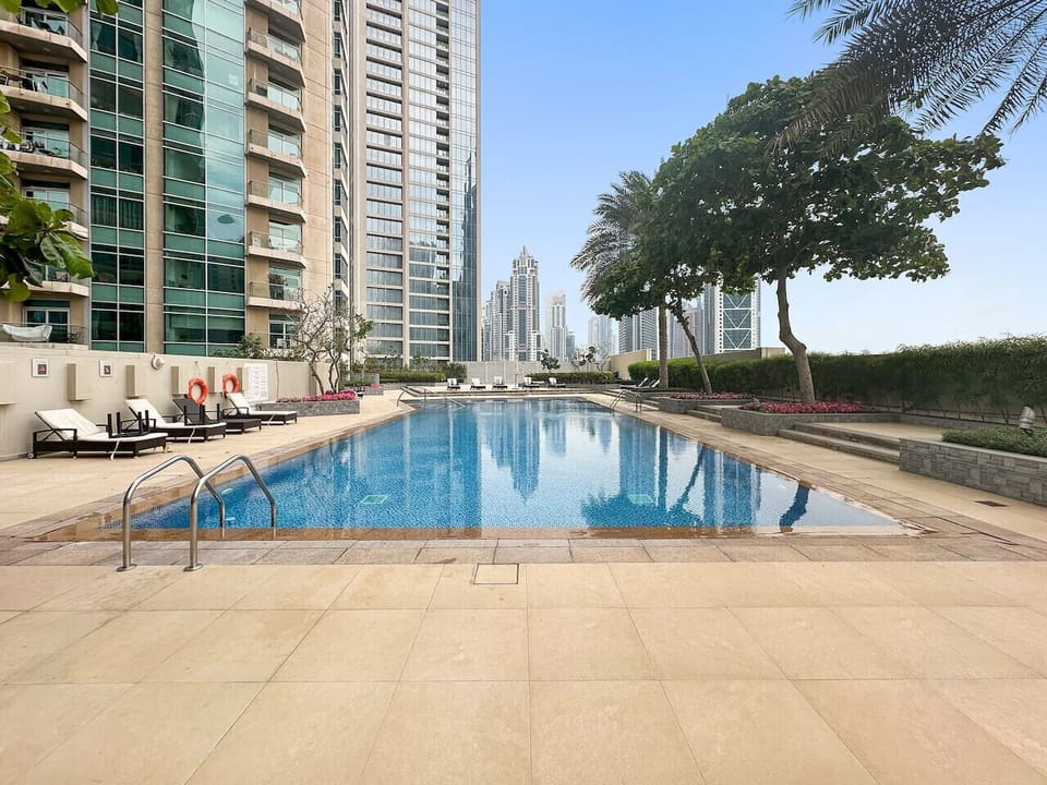 Poolside Retreat: Dive into luxury with stunning skyline views and spacious sun loungers!