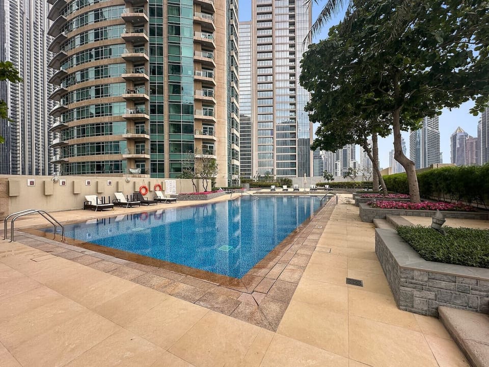 Pool Oasis: Dive into luxury with a stunning view and relax under the sun by the sparkling water!