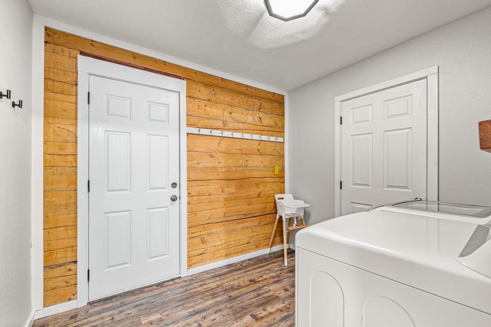 The laundry room is on the main level, and the exit to the deck is open.