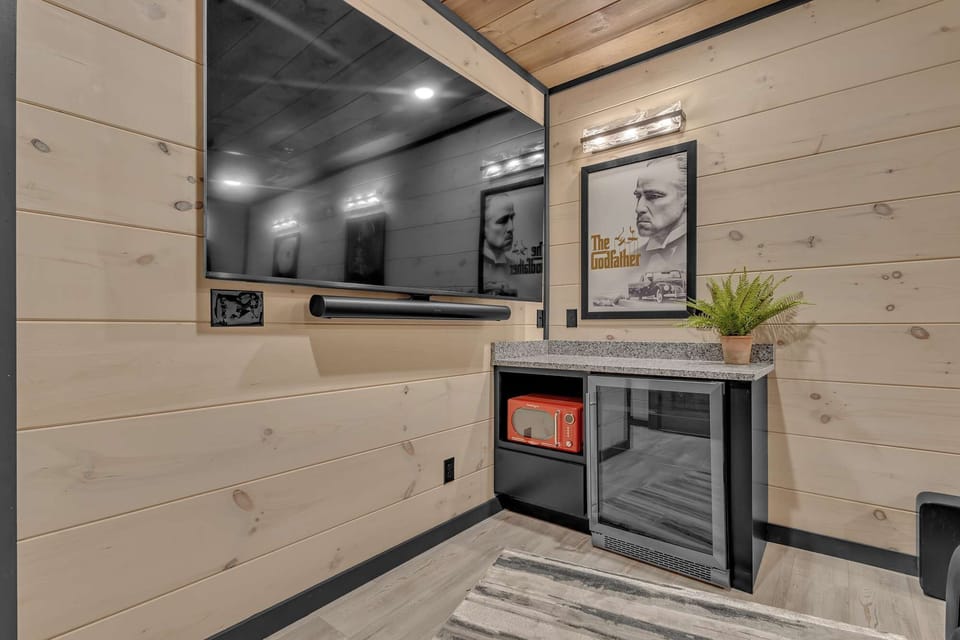 Side view of theater space showing cozy ambiance and entertainment setup.