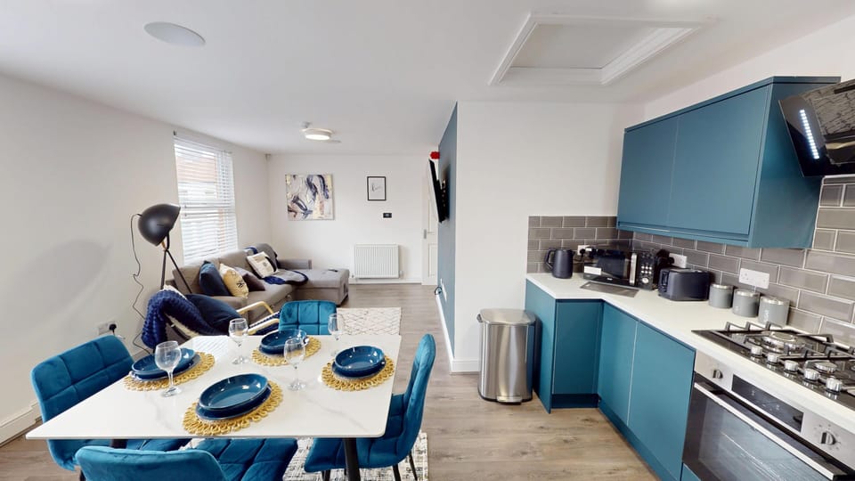 Unwind in the bright living space, featuring a comfortable sofa bed and large Smart TV—perfect for relaxed evenings, movie nights, or accommodating an extra guest with ease